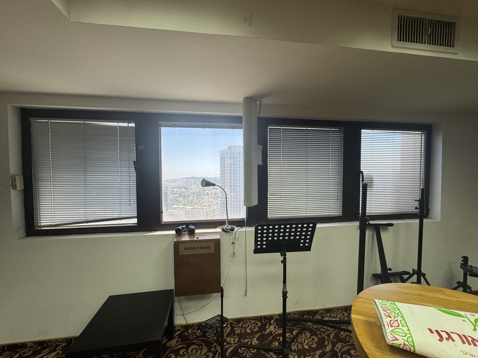 The main hall of the Israel Prayer Tower, its window strip looking out over Jerusalem
